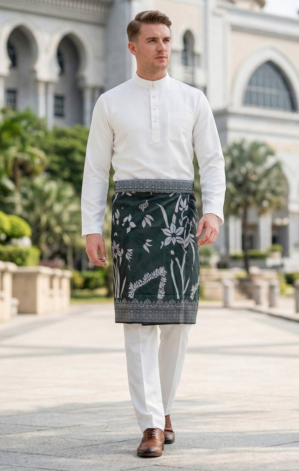 Man wearing a traditional outfit Sampin Instant Tanjung Emerald Silver in an outdoor setting.