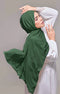 Woman wearing a Emerald Green Shawl Plain hijab and white outfit against a plain background