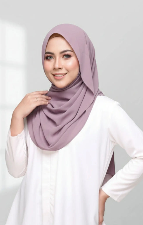 Woman wearing a Semi Instant Shawl Plain Smokey Purple hijab against a white background