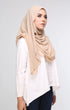 Woman wearing a Nude Semi instant shawl plain front drape view showing full length and soft chiffon texture on a gray background