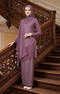 Woman in a Kebaya Moden Dusty Magenta side view on model highlighting long sleeves and fit standing on a wooden staircase with intricate carvings.