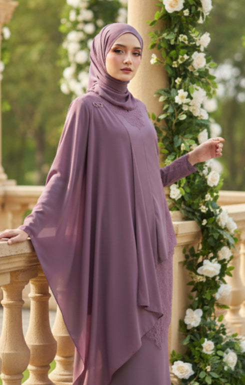Woman in a Kebaya Moden Dusty Magenta model styling shot showing overall dress drape standing outdoors with floral decorations