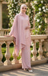 Woman in a Kebaya Moden Rose Gold front view on model showing V-neck and lace details outfit standing on a balcony with floral decorations