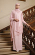 ebaya Moden Rose Gold side view on model highlighting long sleeve fit standing on a staircase with wooden railings.