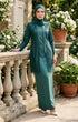 Woman wearing kebaya Kutu Baru Teal Green front view showing V‑neck collar and French lace detailing balcony with floral decorations