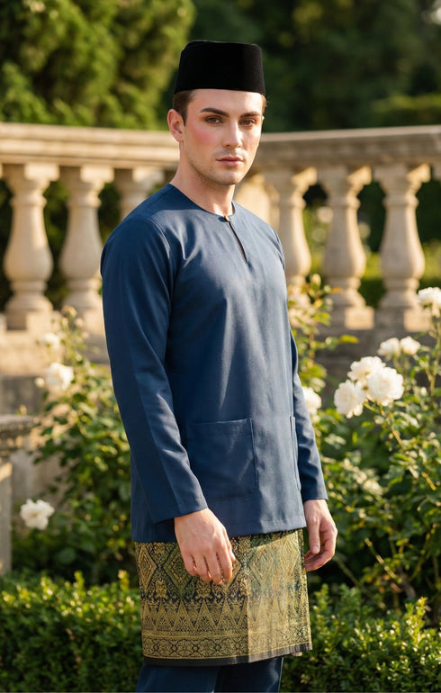 Baju Melayu Teluk Belanga Dark Teal Blue side view showing Long-sleeve and fit in a garden.