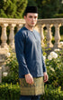 Baju Melayu Teluk Belanga Dark Teal Blue side view showing Long-sleeve and fit in a garden.