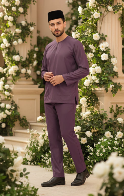 Baju Melayu Teluk Belanga Dusty Magenta standing in front of floral decorations