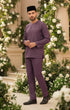Baju Melayu Teluk Belanga Dusty Magenta standing in front of floral decorations
