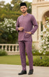Man wearing a Smokey purple traditional Baju melayu teluk belanga outfit standing in an outdoor setting with greenery.