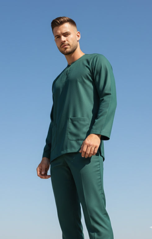 Man wearing a Baju melayu Teal green scrub set against a clear blue sky
