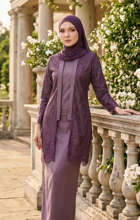 Woman styling kebaya Kutu Baru Dusty Magenta front view with long straight sleeve and shoulder pad detail with floral decorations.