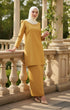 Woman in a Kurung moden plain mustard full outfit view with greenery in the background
