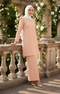 Woman in a Kurung moden plain Peach full side view outfit standing on a stone balcony with floral decorations.
