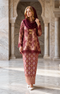 woman wearing Kurung Kedah Lace Songket Maroon full outfit with full songket skirt standing in a marble hall