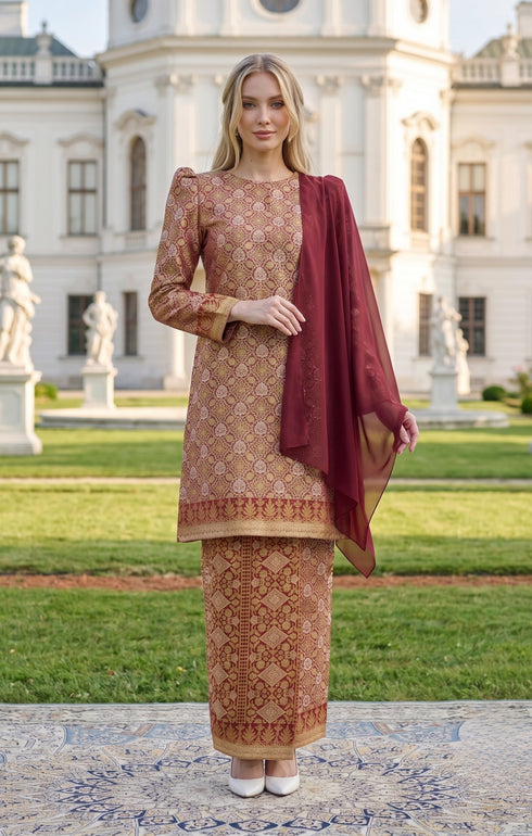 woman wearing Kurung Moden Dyed Brocade Burgundy front view showcasing round neck and elegant silhouette
