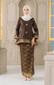 Woman wearing a Kurung Kedah Dark Rich Brown Gold traditional outfit with a matching Instant Shawl in an elegant interior setting.