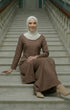 Kebarung Klasik Plain Chocolate outfit sitting on marble steps