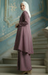Kebarung Dusty Magenta angled side view showing flowy kebarung klasik fit with a decorative blue wall behind her