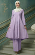Woman in a Kebarung Klasik Plain Dusty Purple front view standing on a staircase with decorative walls.