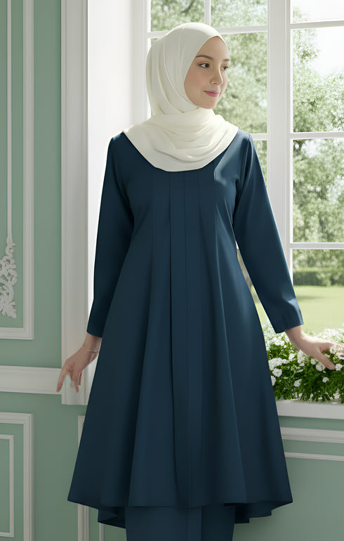 Close-up of Kebarung Klasik Dark Teal Blue showing smooth cotton texture and elegant plain design standing by a window with greenery outside.