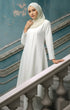 Kebarung Klasik Plain Pearl White full outfit view standing on a decorative staircase.