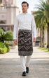 Man wearing Sampin Instant Kasturi Tenun Brown Silver with Baju Melayu traditional outfit front view highlighting velcro waist and weave texture in an outdoor setting.