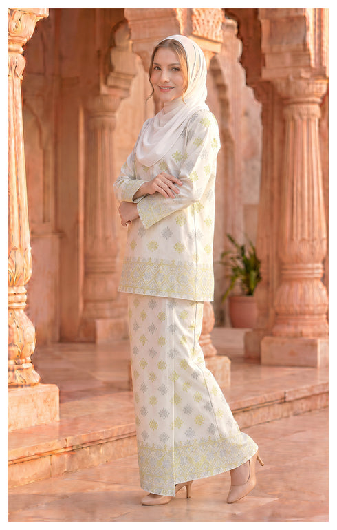 Model wearing Kurung Kedah Pearl White side view showing standard fit silhouette
