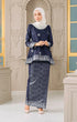 Front view Kurung Kedah Blue Black Silver showing traditional outfit with a matching hijab shawl in an elegant interior setting.