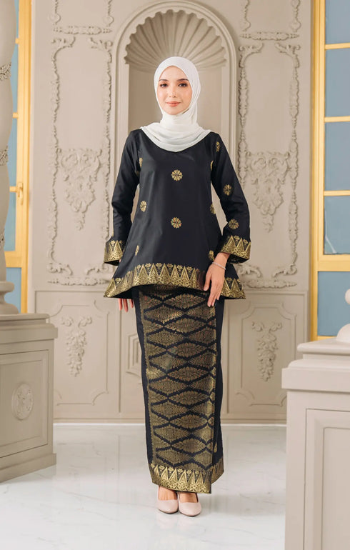 Model wearing Kurung Kedah Black Gold displaying overall styling and drape