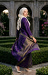Woman in a purple Gold Baju kebaya songket bunga tabur walking through an architectural garden.