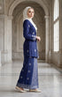 Woman in a blue traditional Kebaya Kurung Moden Songket Dark Royal Blue Silver angled side view standing in a marble hallway.