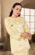 Model in soft yellow Sophia Kurung Kedah