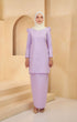 A woman wearing a Kurung Moden Plain Dusty Purple, solid-patterned, long-sleeved traditional dress with a round neckline, standing against a neutral background.