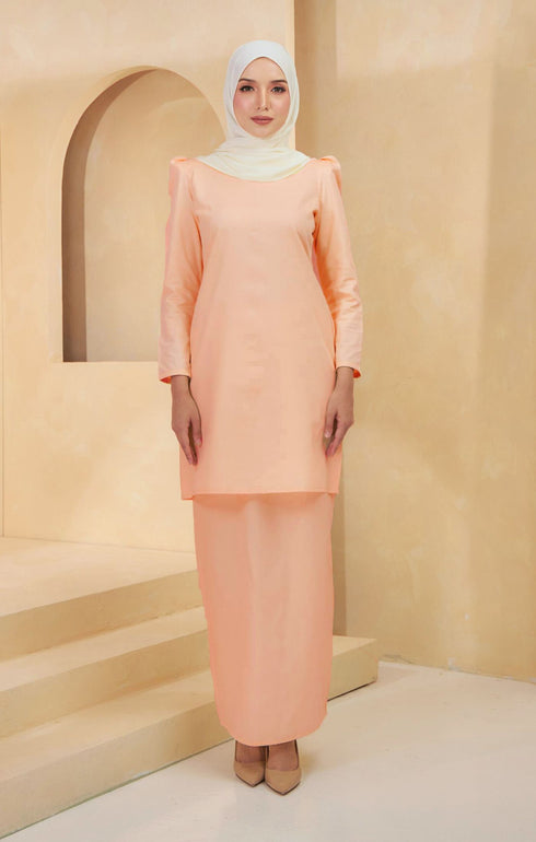 Kurung Moden Plain Peach front view on model showing round neck and puff shoulders